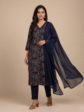 Woman wearing a floral kurta with a navy dupatta on a beige background