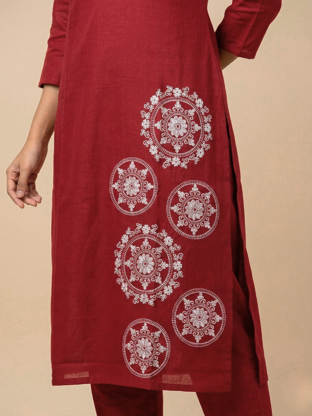 Red kurta with white embroidery on a beige background