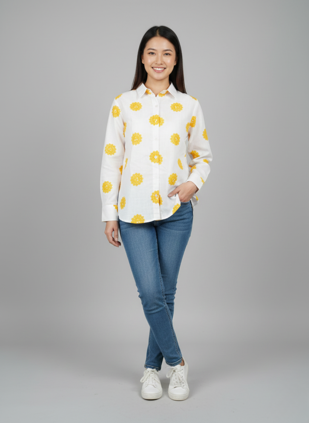 gray parrot shirt Woman wearing a white shirt with yellow patterns and blue jeans on a gray background