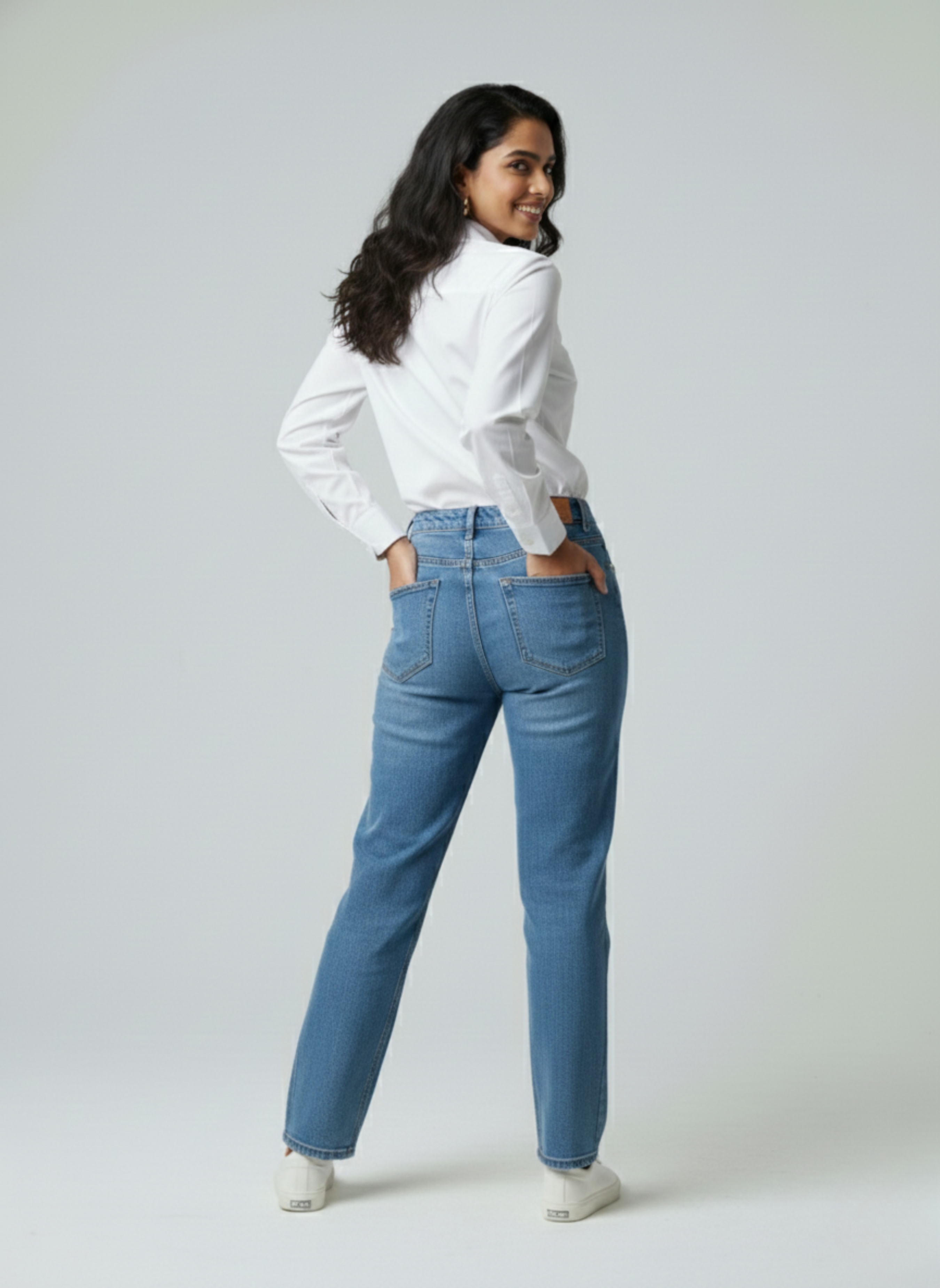 Gray parrot Woman wearing a white shirt and blue jeans on a plain background