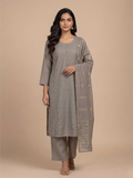 Woman wearing a gray kurta with a matching drape against a beige background